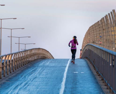 person running over a bridge